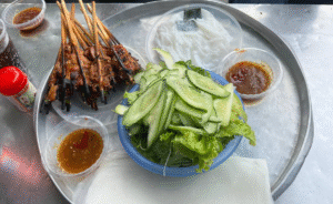 Grilled skewers with fresh vegetables and sauce in Da Nang Food Tours by X.o Food Tours