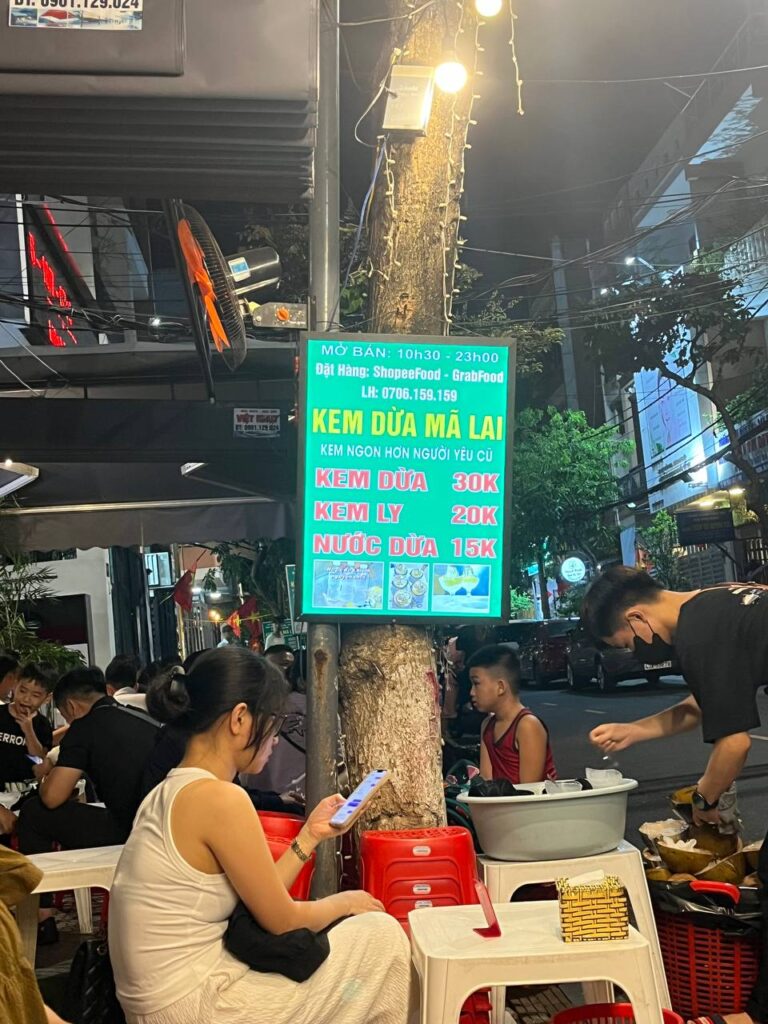 Teenagers are eating street food in Da Nang at Kem Dua Ma Lai