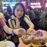 Vietnamese people toasting with da nang beer and seafood